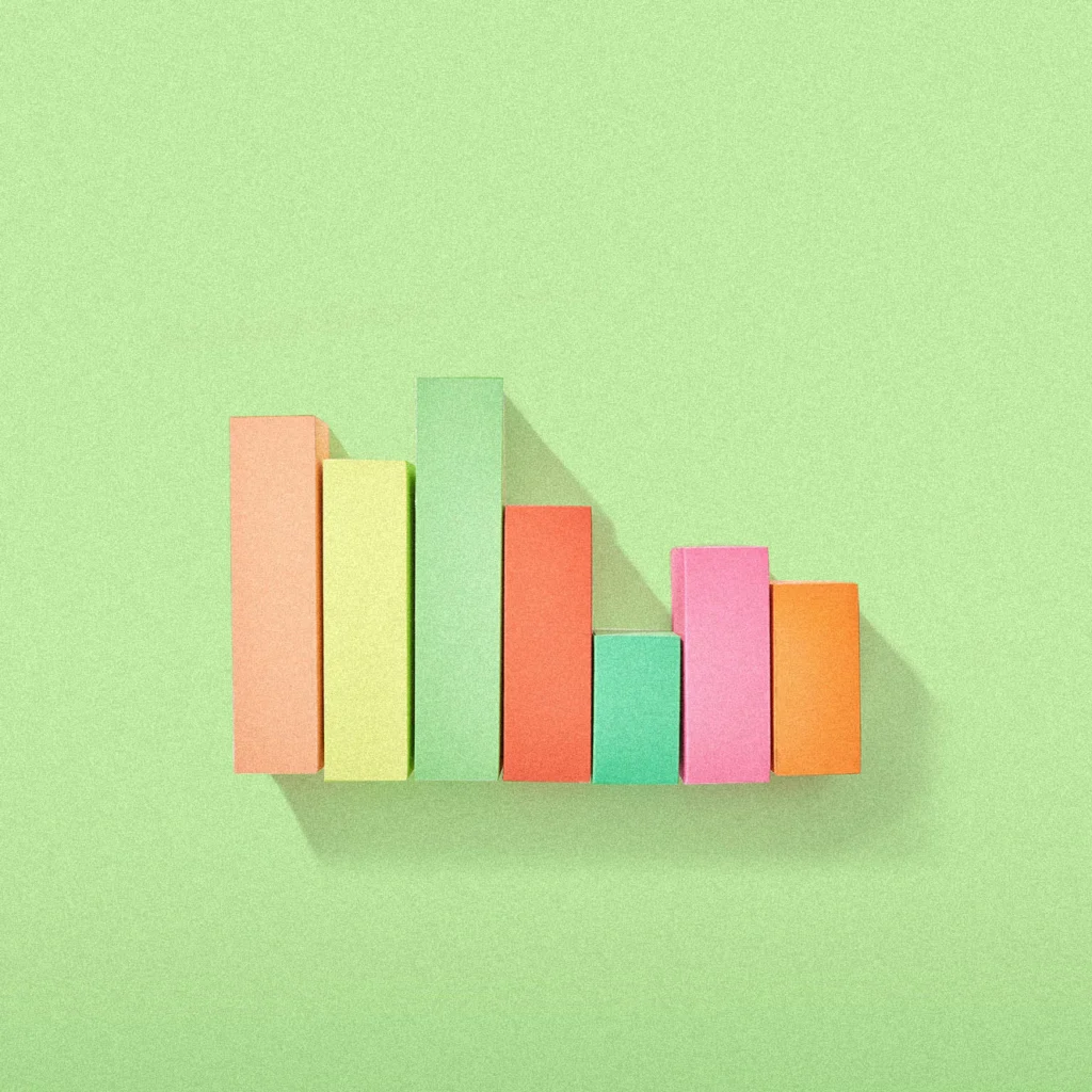 Colored wooden blocks a green background in a bar graph formation.