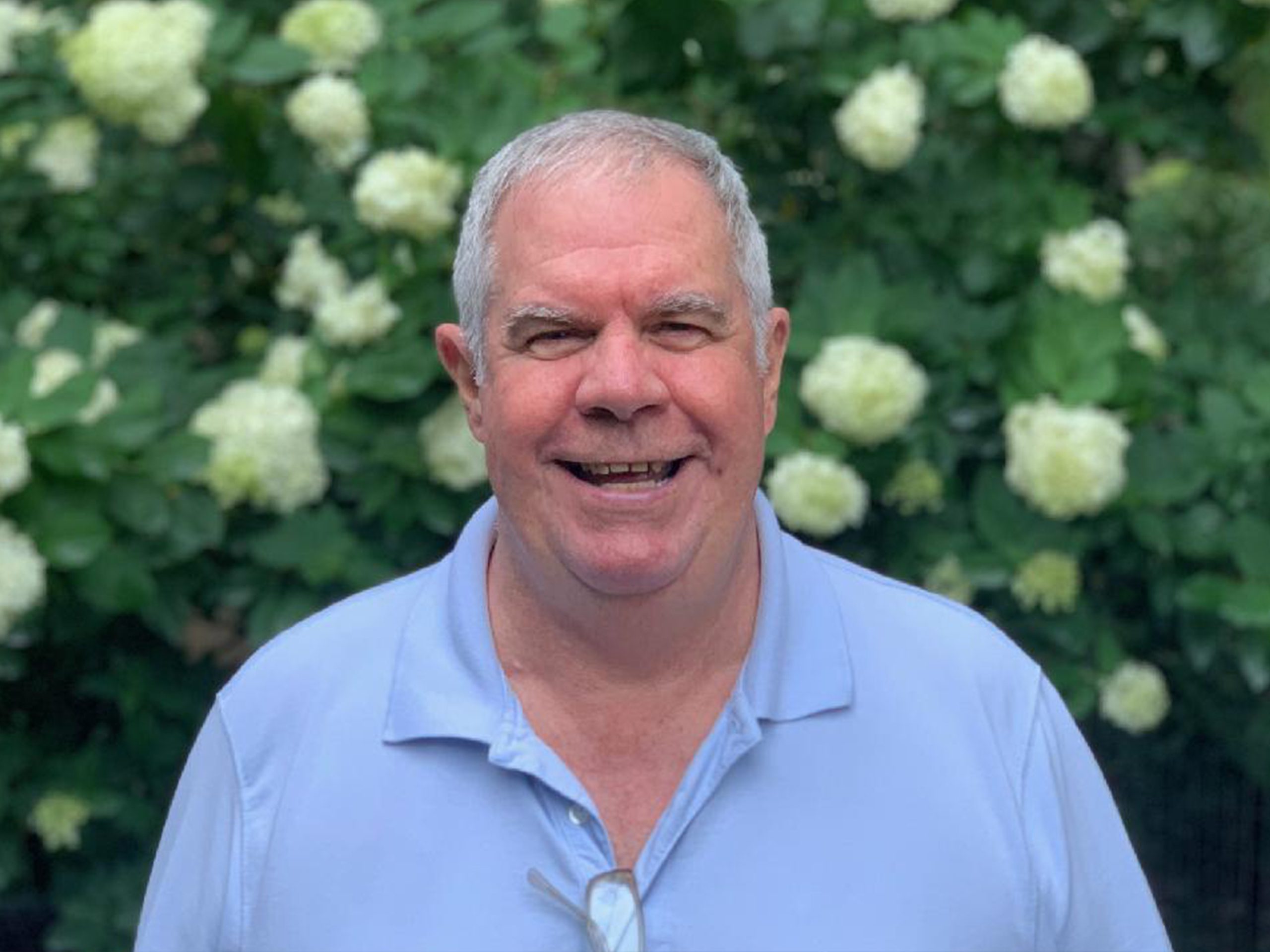 Caucasian man standing in front of flowers