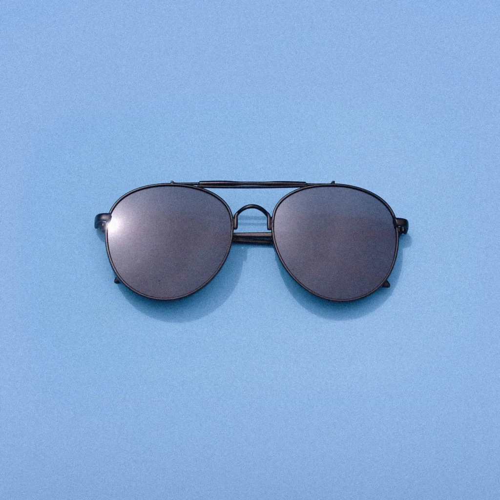 Aviator sunglasses on a blue background.