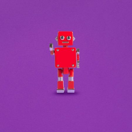 Red Robot isolated on a purple background.