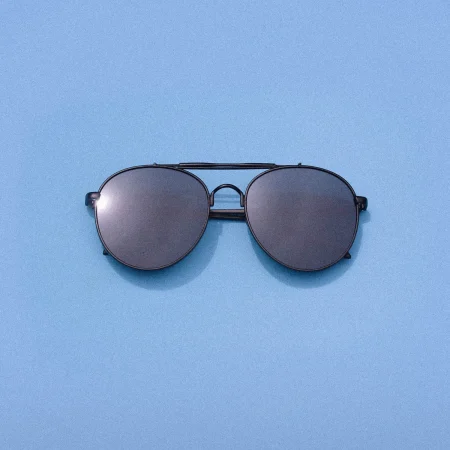 Aviator sunglasses on a blue background.