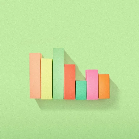 Colored wooden blocks a green background in a bar graph formation.