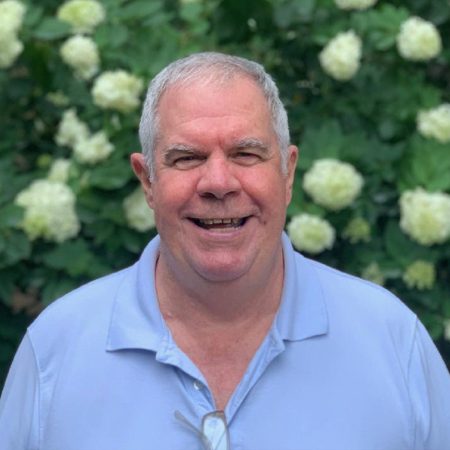 Caucasian man standing in front of flowers